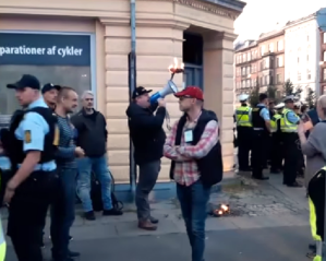 Burning of Quran under police protection in Norrebro, Copenhagen, Denmark in 2019. 