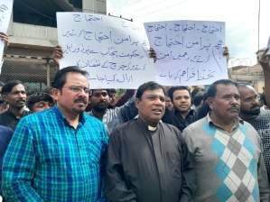 The Rev. Adeem Alphonse (c) and others demand justice after fire at church building in Gujar Khan, Rawalpindi District, Pakistan on March 30, 2024. 