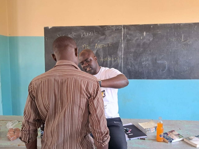 Hawi's juvenile prison ministry included sewing buttons on the boys shirts.