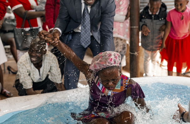 A woman is baptized in a church in Kenya