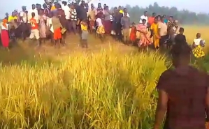 Villagers gather where the body of James Mukenye Habiibu was found on Dec. 17, 2024 in Kibuku District, Uganda.