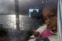 young girl from Sierra Leone looks out a window as the Migrant Offshore Aid Station (MOAS), Italy, Mediterranean, migration