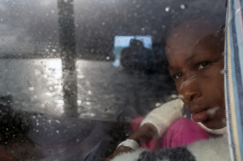 young girl from Sierra Leone looks out a window as the Migrant Offshore Aid Station (MOAS), Italy, Mediterranean, migration